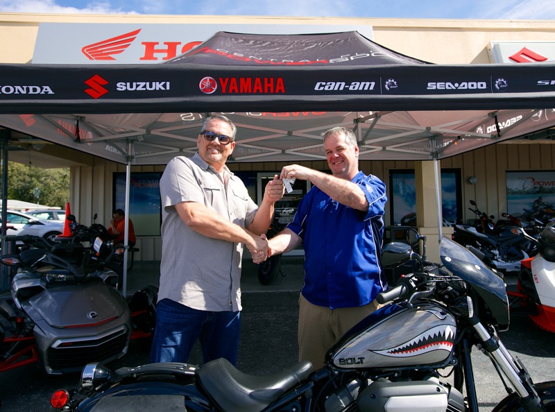 Earl Evans is presented with the keys to a custom Star Motorcycles Bolt R-Spec, courtesy of Brian Fitzpatrick at Central Florida Powersports.