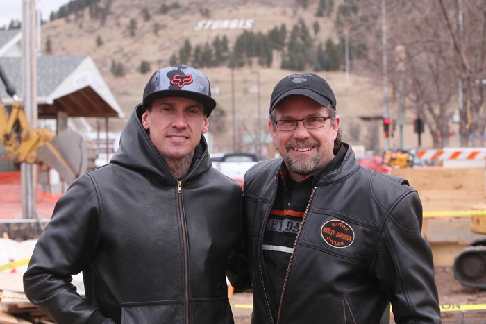 Carey Hart and Bill Davidson in front of the Sturgis sign.