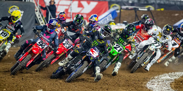 Reigning Monster Energy AMA Supercross Champion Eli Tomac (3) leading a star-studded field into the first turn at State Farm Stadium in Glendale, Ariz.